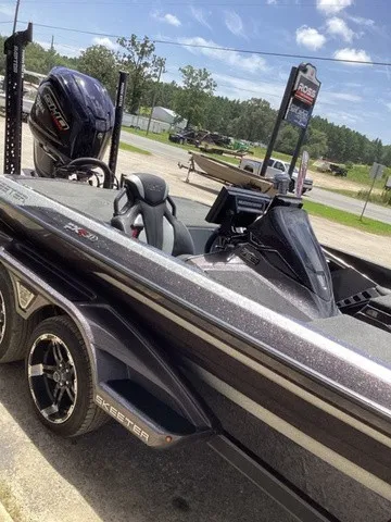 Slide: The Image of A 2023 Skeeter FXR21 boat on a trailer, featuring a powerful outboard motor. - 32
