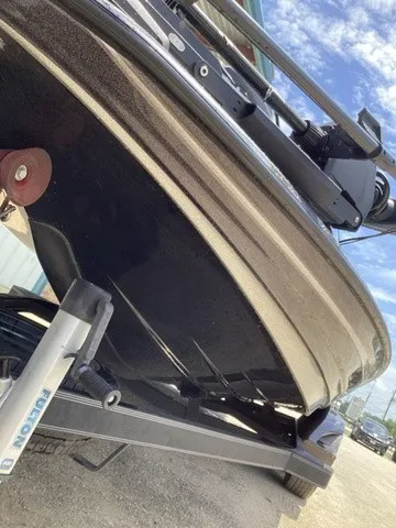 Slide: The Image of Close-up of the hull of a 2023 Skeeter FXR21 boat on a trailer. - 20