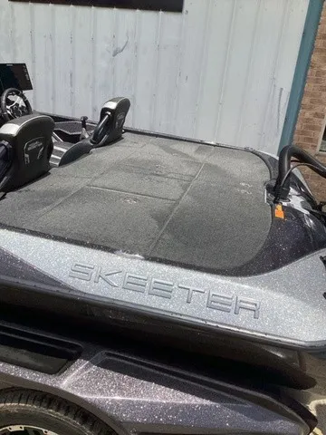 Slide: The Image of The image shows a 2023 Skeeter FXR21 boat with a spacious deck. - 8