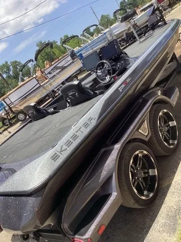 Slide: The Image of A 2023 Skeeter FXR21 boat on a trailer, featuring a modern cockpit and sleek lines. - 48