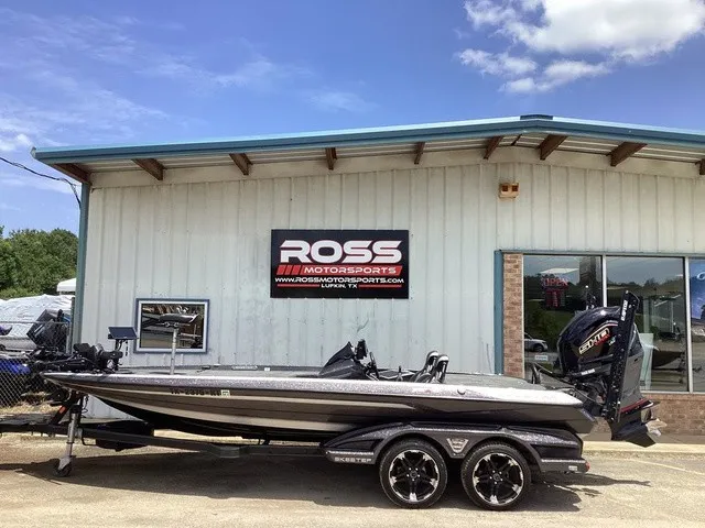 The Image of A 2023 Skeeter FXR21 boat on a trailer in front of a building with a Ross Motorsports sign. - 1