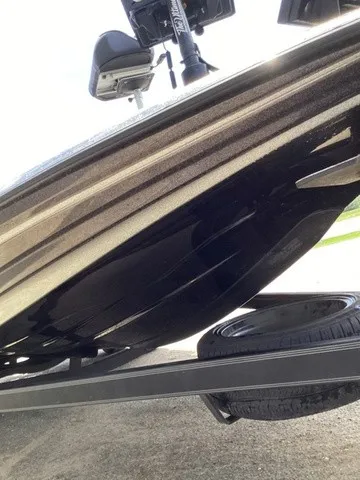 Slide: The Image of Close-up of the hull of a 2023 Skeeter FXR21 boat on a trailer. - 27