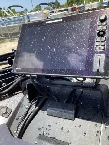 Slide: The Image of A modern navigation system on a 2023 Skeeter FXR21 boat, covered with water droplets. - 45