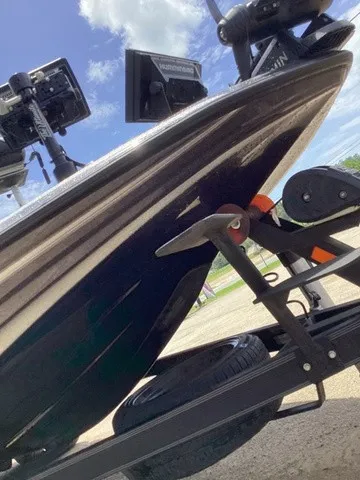 Slide: The Image of Close-up of the bow of a 2023 Skeeter FXR21 boat on a trailer. - 26