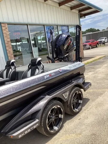 Slide: The Image of A 2023 Skeeter FXR21 boat on a trailer outside a building. - 15
