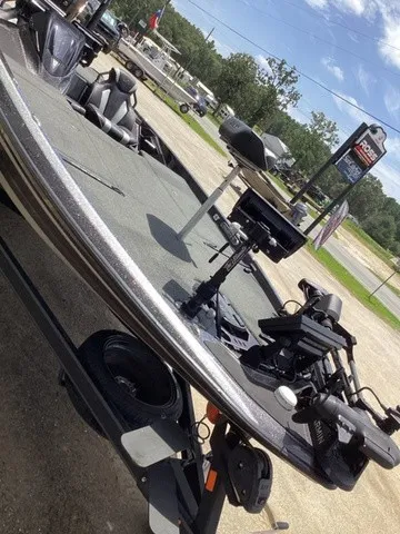 Slide: The Image of A 2023 Skeeter FXR21 boat on a trailer, featuring a well-equipped deck and fishing gear. - 29