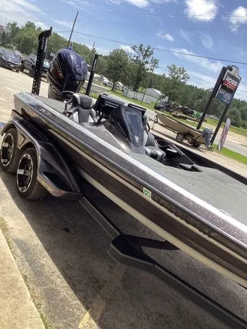 Slide: The Image of A 2023 Skeeter FXR21 boat on a trailer in a parking lot. - 31