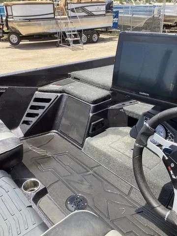 Slide: The Image of The image shows the cockpit of a 2023 Skeeter FXR21 boat with a large Garmin screen. - 42