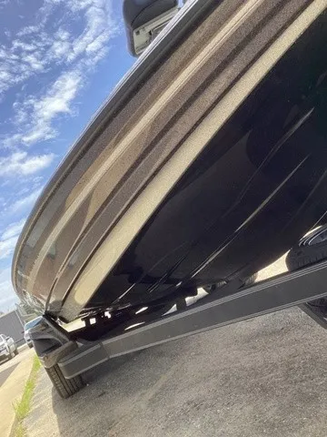 Slide: The Image of Close-up of a 2023 Skeeter FXR21 boat hull on a trailer under a blue sky. - 28