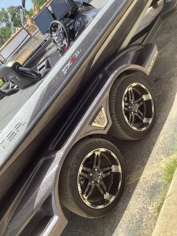 Slide: The Image of A 2023 Skeeter FXR21 boat on a trailer with stylish rims and a modern cockpit. - 50