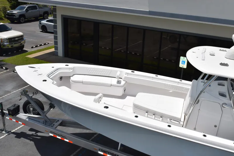 Slide: The Image of 2027 Contender 39 ST boat on trailer in parking lot, side view. - 9