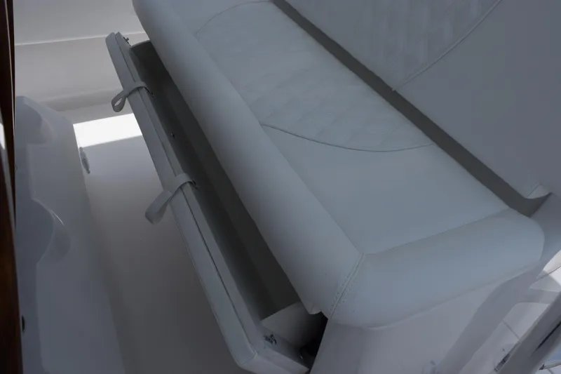 Slide: The Image of 2027 Contender 39 ST boat seat with storage compartment, featuring white upholstery. - 41