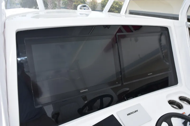 Slide: The Image of Dashboard of 2027 Contender 39 ST boat with dual Garmin displays. - 28