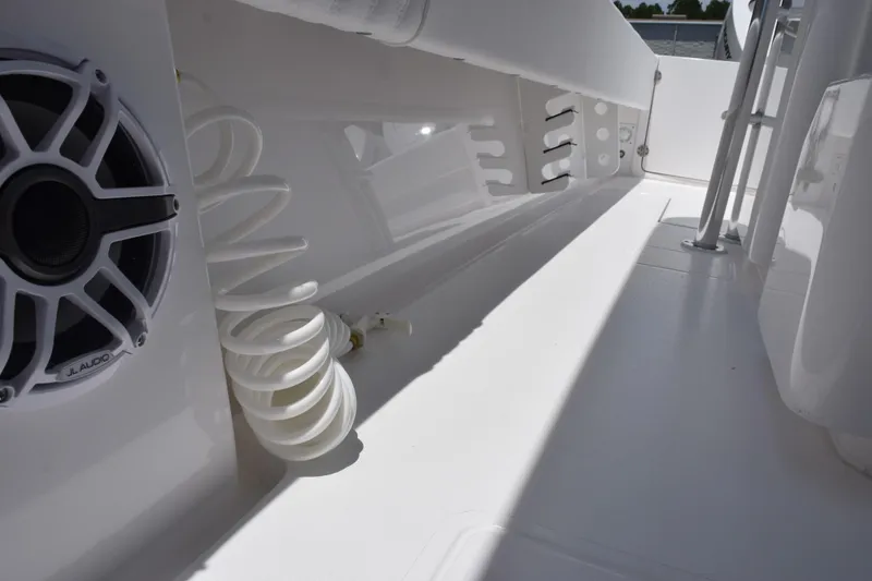 Slide: The Image of Interior view of a 2027 Contender 39 ST boat featuring a JL Audio speaker and coiled hose. - 26