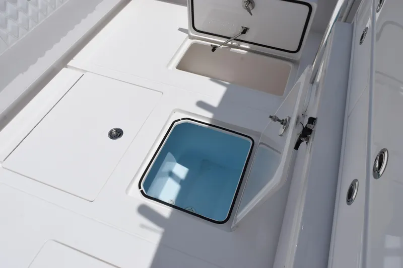 Slide: The Image of Contender 39 ST 2027 boat deck with open storage compartments and sleek design. - 45