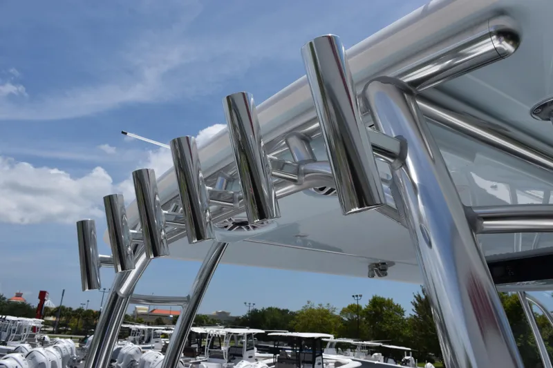 Slide: The Image of Stainless steel rod holders on a 2027 Contender 39 ST boat under a clear blue sky. - 51