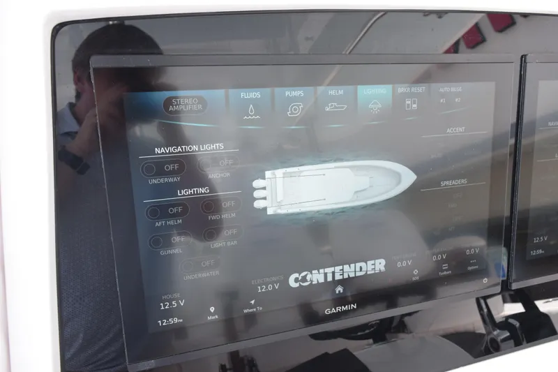 Slide: The Image of Touchscreen control panel of a 2027 Contender 39 ST boat, displaying navigation and lighting options. - 32
