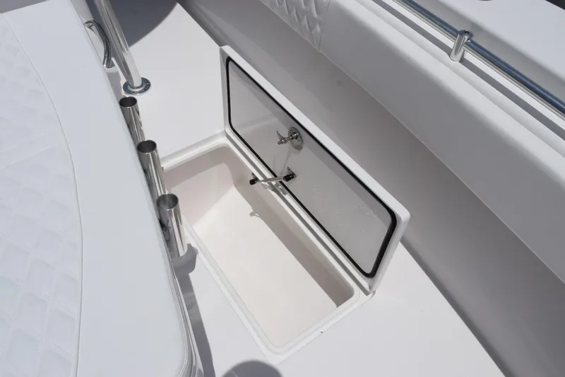 Slide: The Image of 2027 Contender 39 ST boat storage compartment with open hatch and rod holders. - 37