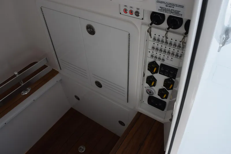 Slide: The Image of Electrical panel and storage area inside a 2027 Contender 39 ST boat. - 20
