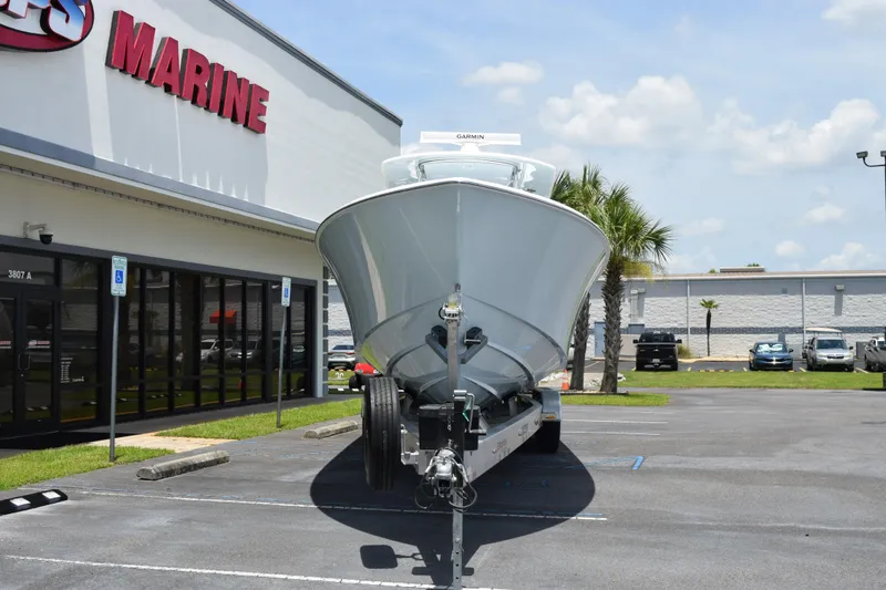 Slide: The Image of Front view of a 2027 Contender 39 ST boat on a trailer outside a marine store. - 3