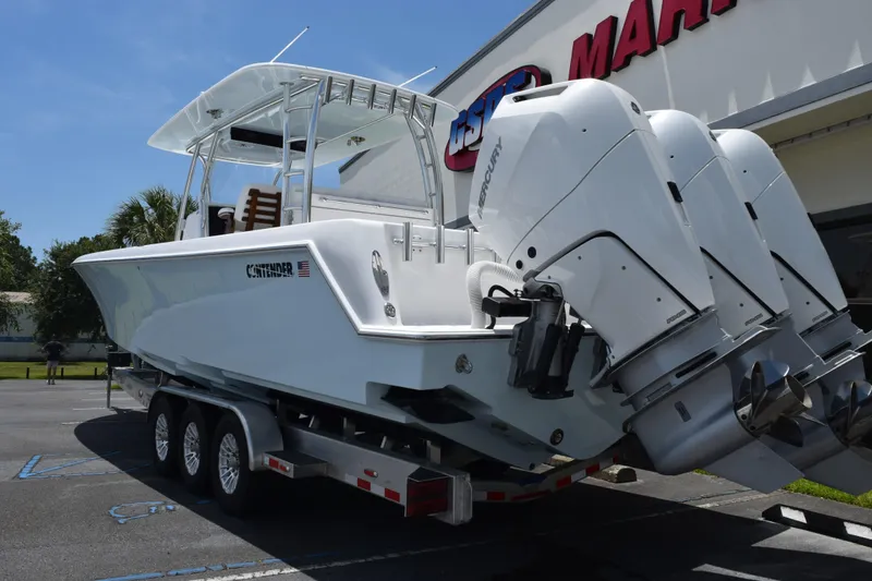 Slide: The Image of 2027 Contender 39 ST boat on trailer with triple Mercury outboard engines. - 4