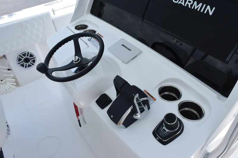 Slide: The Image of Steering console of 2027 Contender 39 ST boat with Garmin display and Mercury controls. - 24