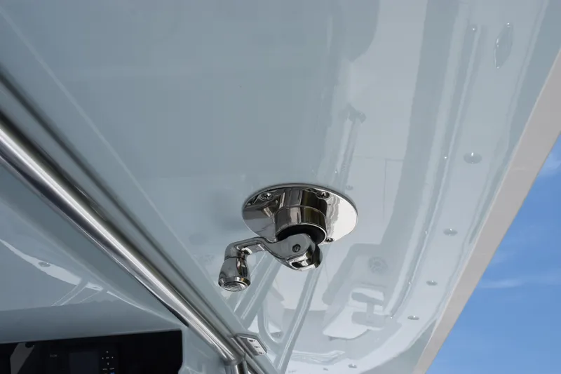 Slide: The Image of Close-up of a 2027 Contender 39 ST boat's polished metal fitting against a blue sky. - 52