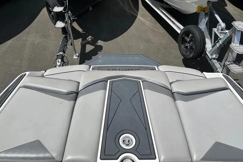 Slide: The Image of 2015 Supra SA 400 boat interior with sleek gray seating and trailer in background. - 16