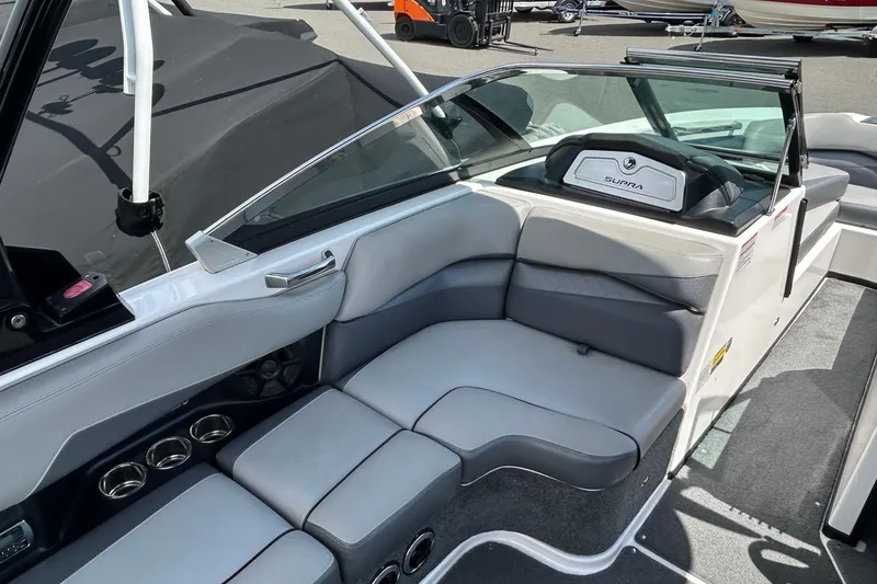 Slide: The Image of 2015 Supra SA 400 boat interior with gray seating and cup holders. - 9
