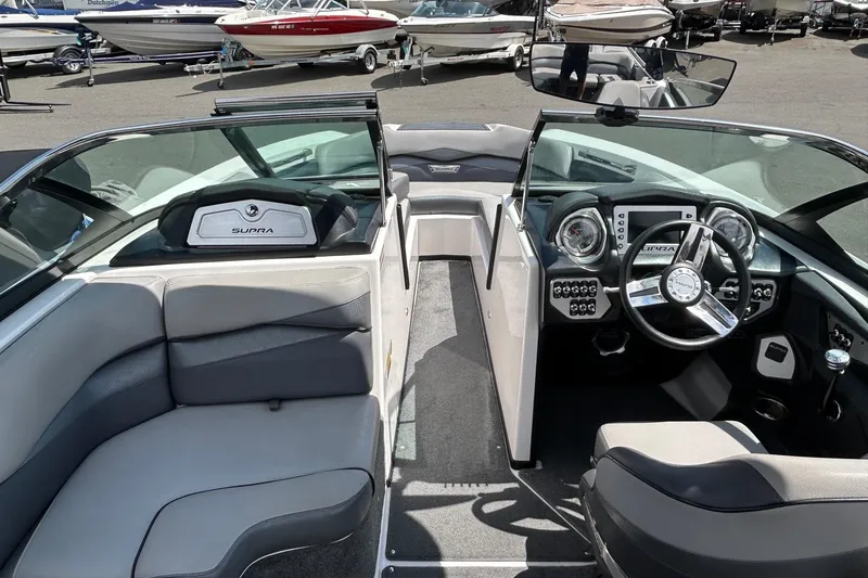 Slide: The Image of Interior of a 2015 Supra SA 400 boat with modern dashboard and seating. - 10
