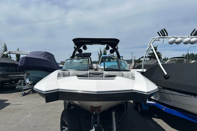Slide: The Image of 2015 Supra SA 400 boat parked in a marina, surrounded by other covered boats. - 3