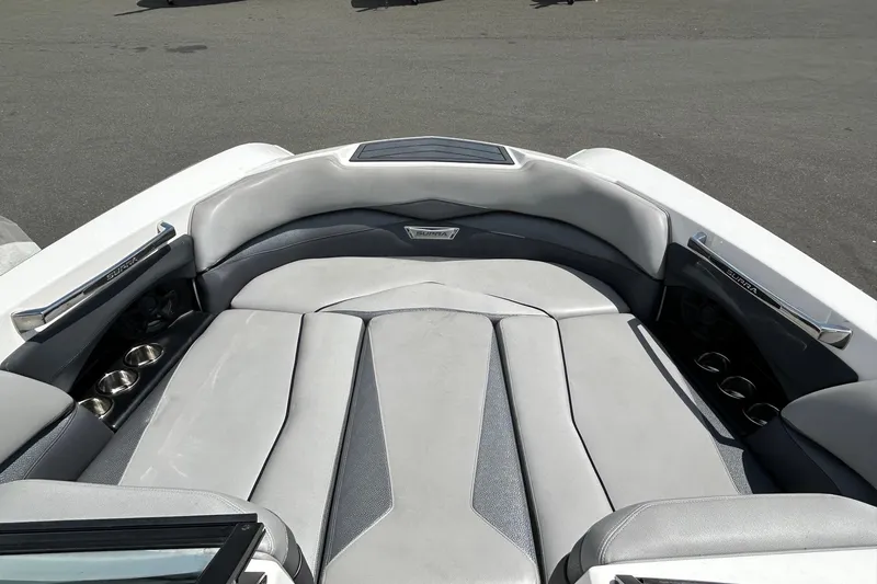 Slide: The Image of 2015 Supra SA 400 boat interior with gray seating and cup holders. - 14