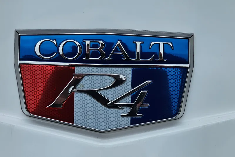Slide: The Image of 2023 Cobalt R4 emblem with red, white, and blue design on a white background. - 31