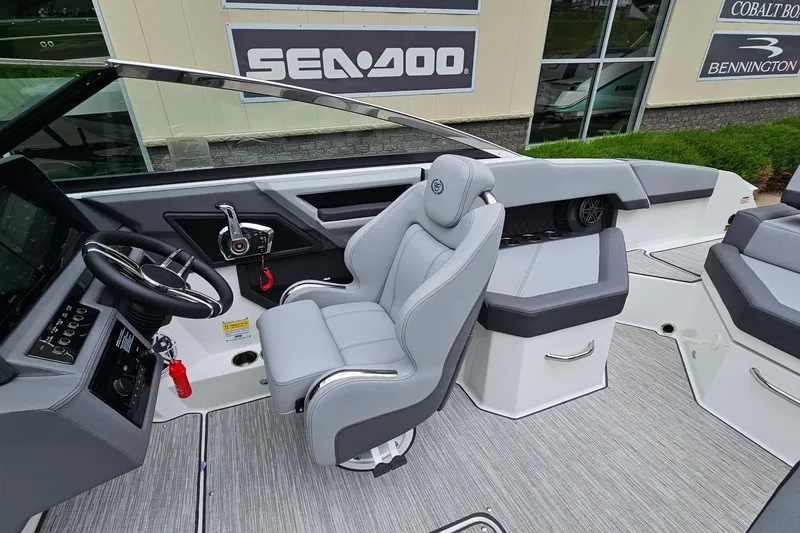 Slide: The Image of 2023 Cobalt R4 boat interior with sleek gray seating and modern dashboard controls. - 14