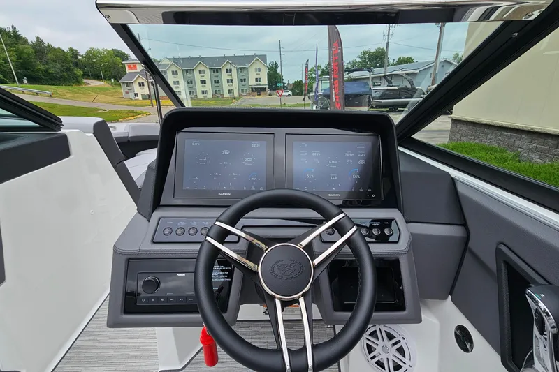 Slide: The Image of 2023 Cobalt R4 boat dashboard with modern steering wheel and digital display. - 16