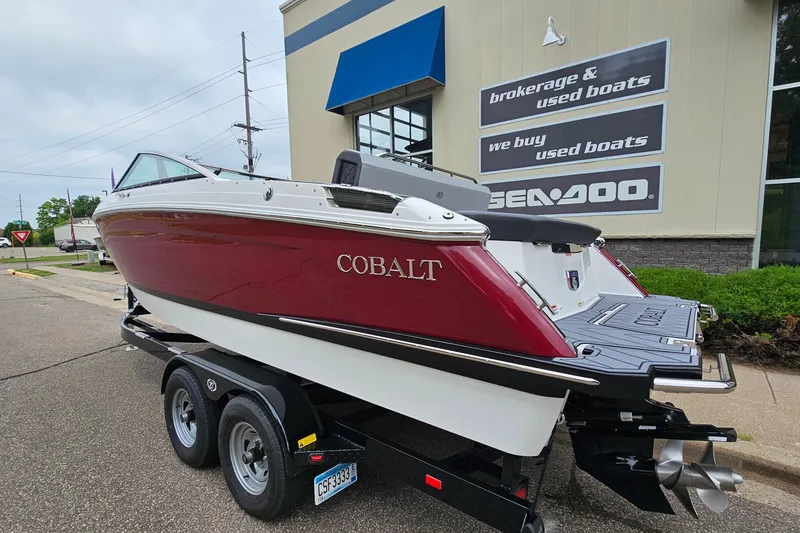 Slide: The Image of 2023 Cobalt R4 boat on trailer outside dealership, showcasing sleek design and vibrant color. - 4