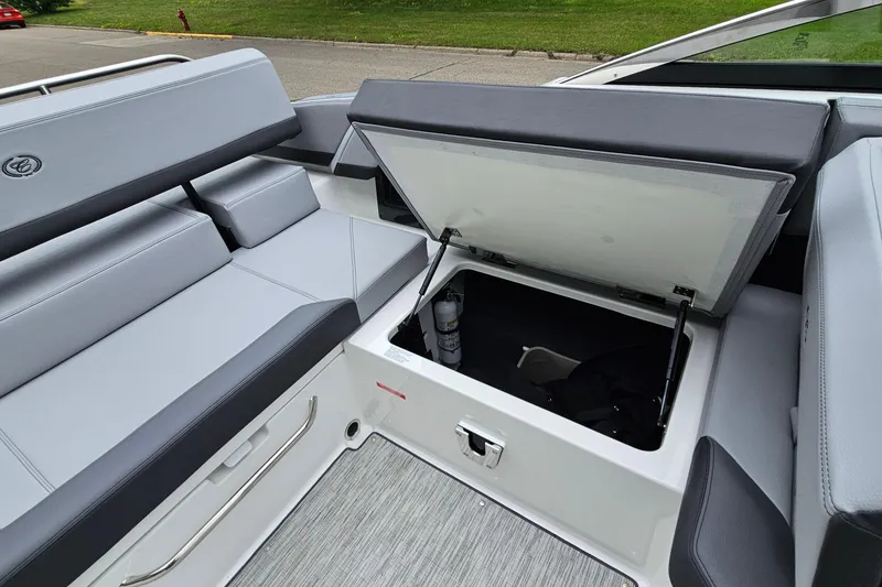 Slide: The Image of 2023 Cobalt R4 boat interior with open storage compartment and cushioned seating. - 27