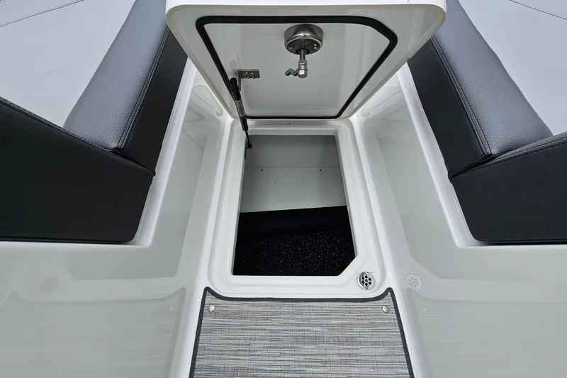 Slide: The Image of 2023 Cobalt R4 boat storage compartment with open hatch and black seating. - 24