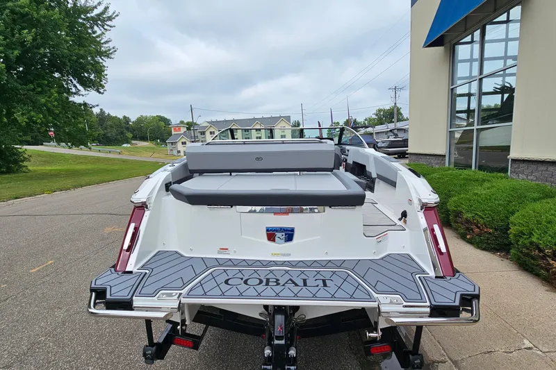 Slide: The Image of 2023 Cobalt R4 boat rear view, parked outdoors near a building. - 5