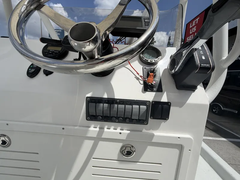 Slide: The Image of The image shows the helm of a 2015 Mowdy C-25 boat with various instruments. - 20