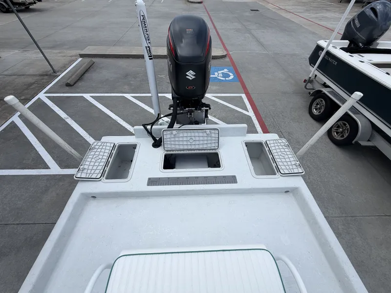 Slide: The Image of The image shows the stern of a 2015 Mowdy C-25 boat with a Suzuki outboard motor. - 12