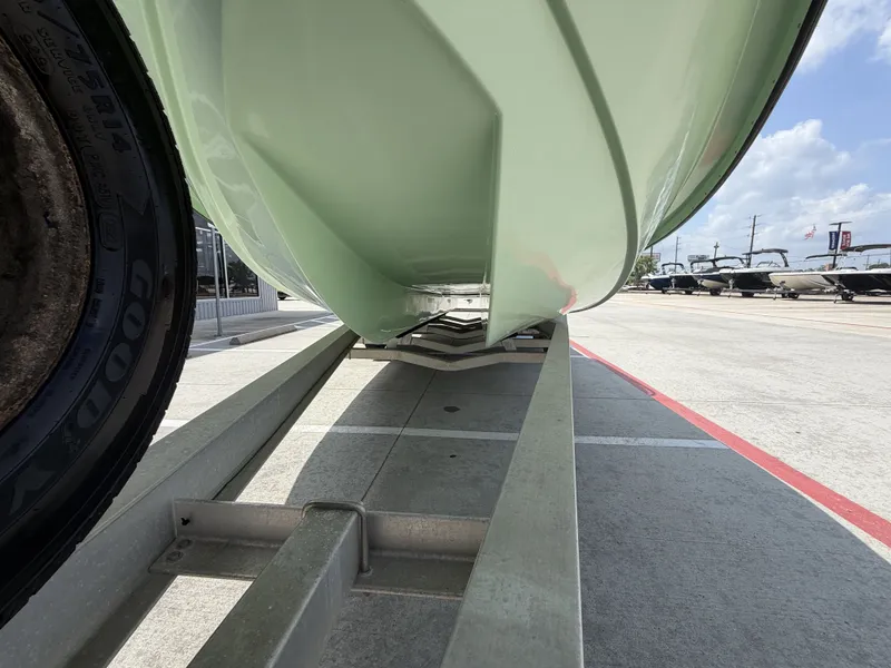 Slide: The Image of A green boat on a trailer, ready for transport. - 5