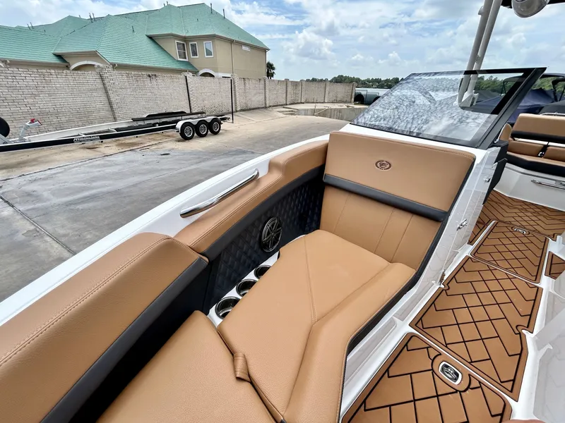 Slide: The Image of The image shows the cockpit of a 2027 Cobalt R4 boat with beige upholstery and sleek details. - 22