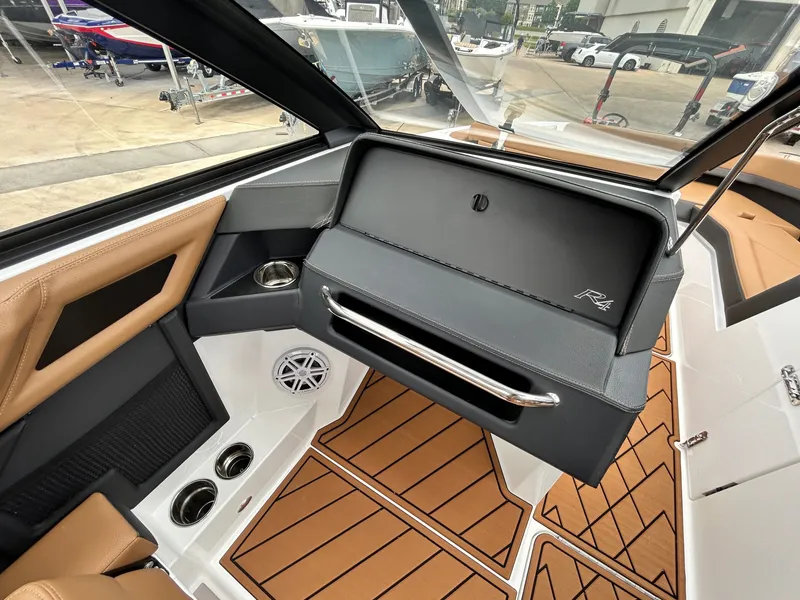 Slide: The Image of The image shows the cockpit of a 2027 Cobalt R4 boat with sleek brown and gray accents. - 39