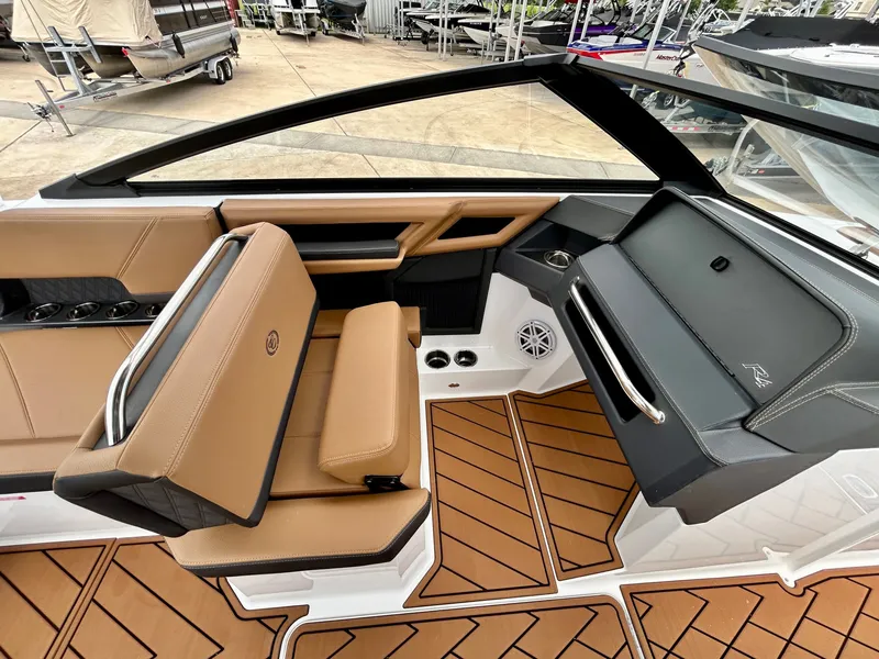 Slide: The Image of The image shows the cockpit of a 2027 Cobalt R4 boat with brown leather seats and a modern dashboard. - 40