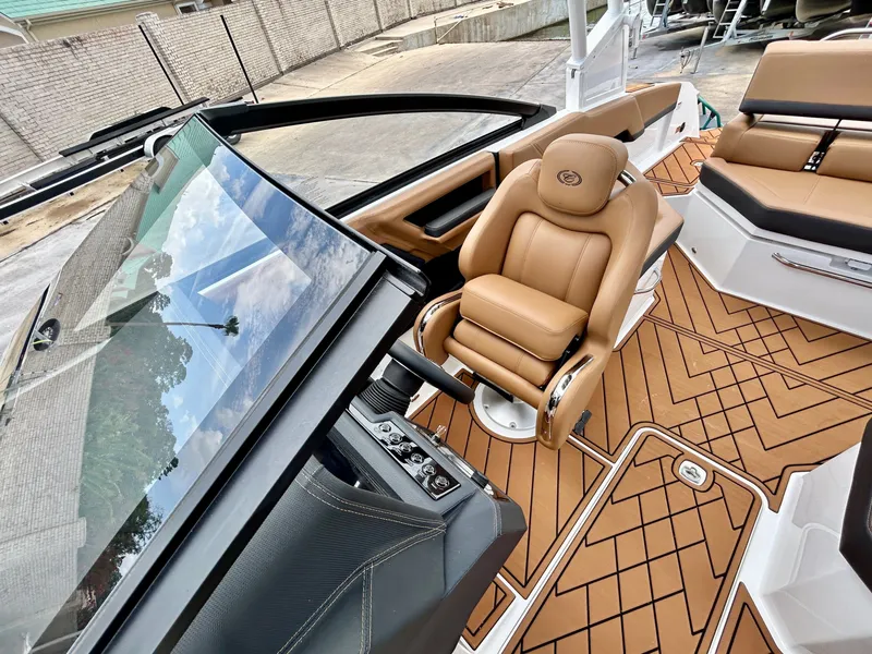 Slide: The Image of The image shows the cockpit of a 2027 Cobalt R4 boat with luxurious leather seating. - 26