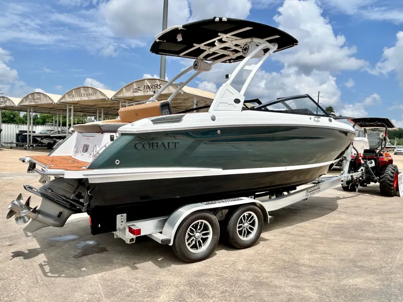 Slide: The Image of A sleek 2027 Cobalt R4 boat on a trailer. It features a modern design and black hull color. - 7