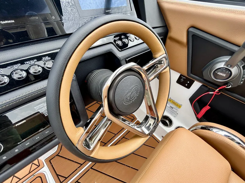 Slide: The Image of The image shows the cockpit of a 2027 Cobalt R4 boat with a sleek steering wheel and modern instruments. - 29