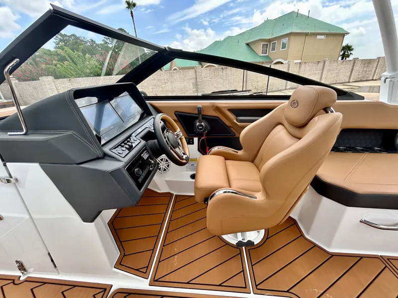 Slide: The Image of The image shows the cockpit of a 2027 Cobalt R4 boat with sleek, modern design. - 32