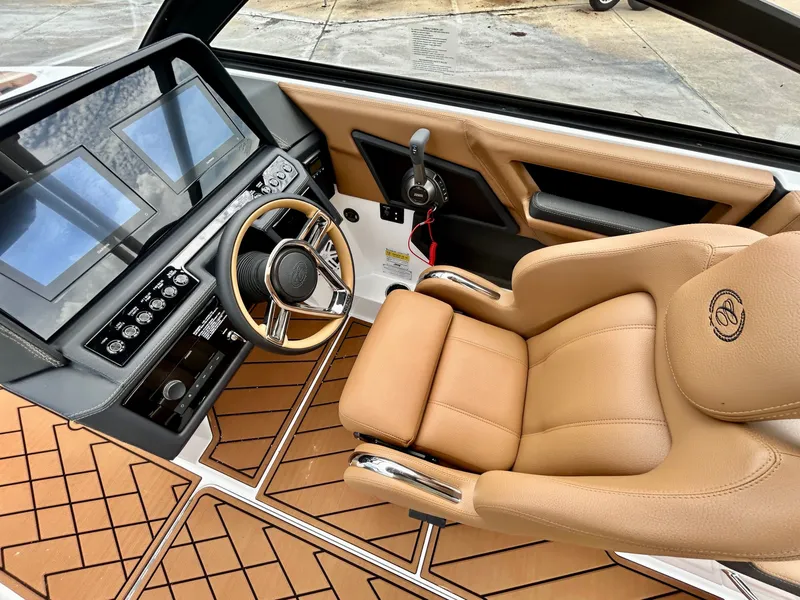 Slide: The Image of The image shows the cockpit of a 2027 Cobalt R4 boat with a luxurious leather seat. - 28